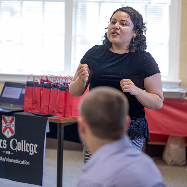 A Latina student speaking at orientation for the master's program