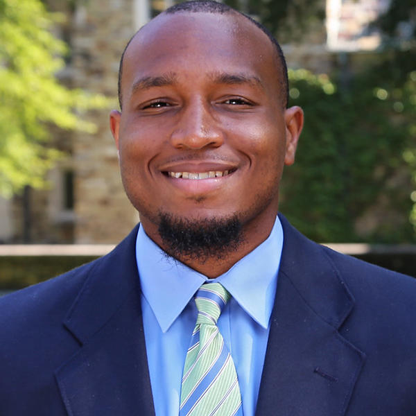 a young African American man in a blue suit and tie