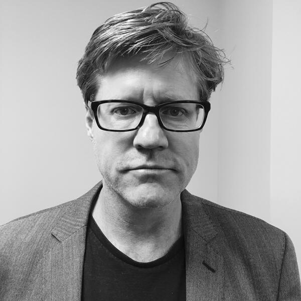 head shot of a man in glasses