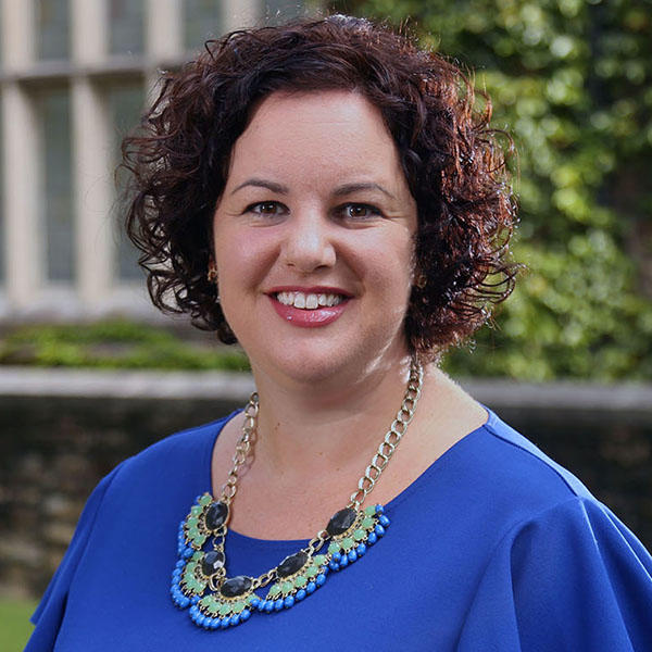 a woman with short curly brown hair
