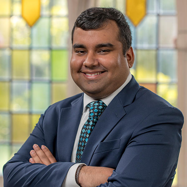 a young Indian American man in a suit