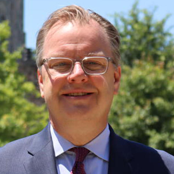 a man in a suit and glasses