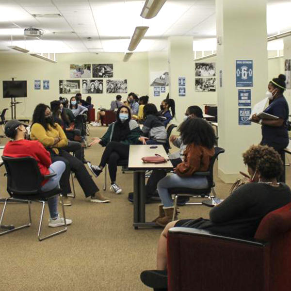 a multicultural group of students meets in a large room