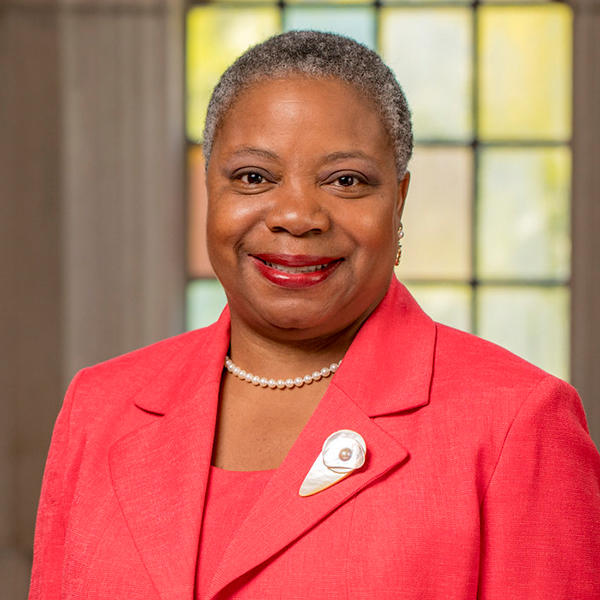 an African American woman in a red suit