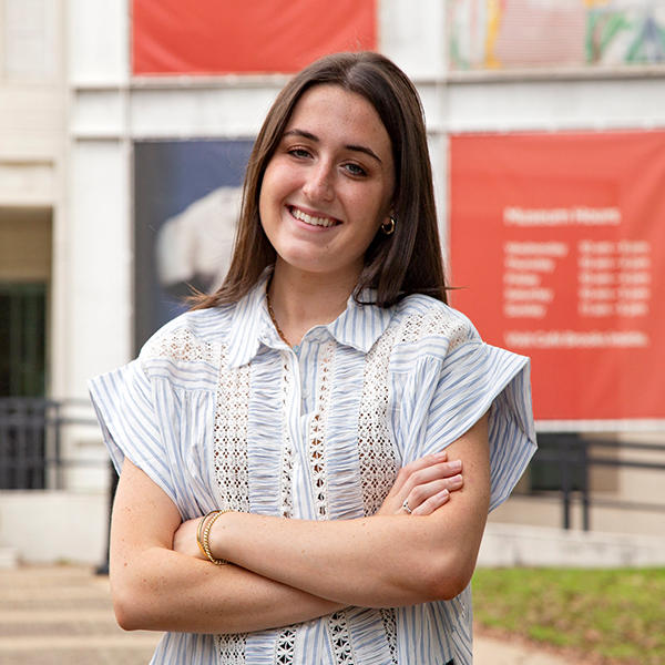 a female student stands in front of Brooks Museum