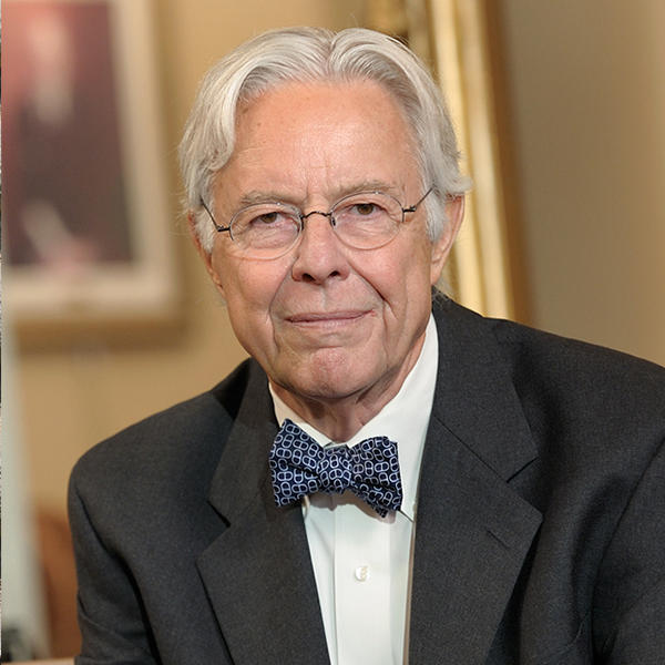 an older man with glasses and a bow tie