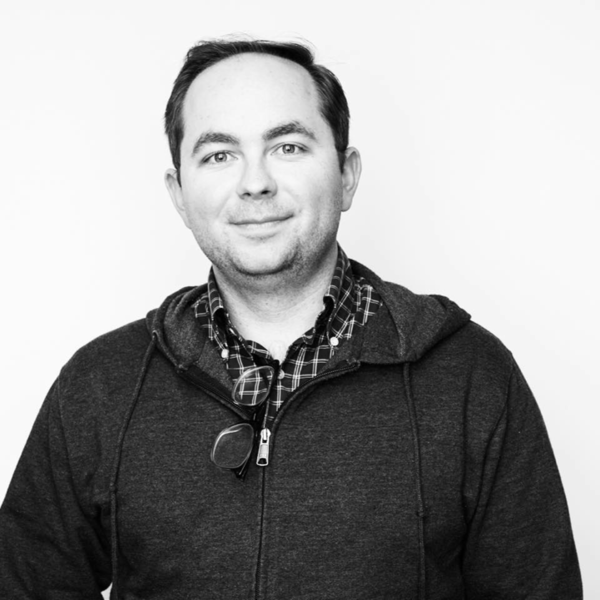 a man with dark hair smiles at the camera