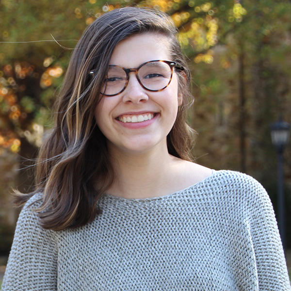 a young woman with brown hair and glasses