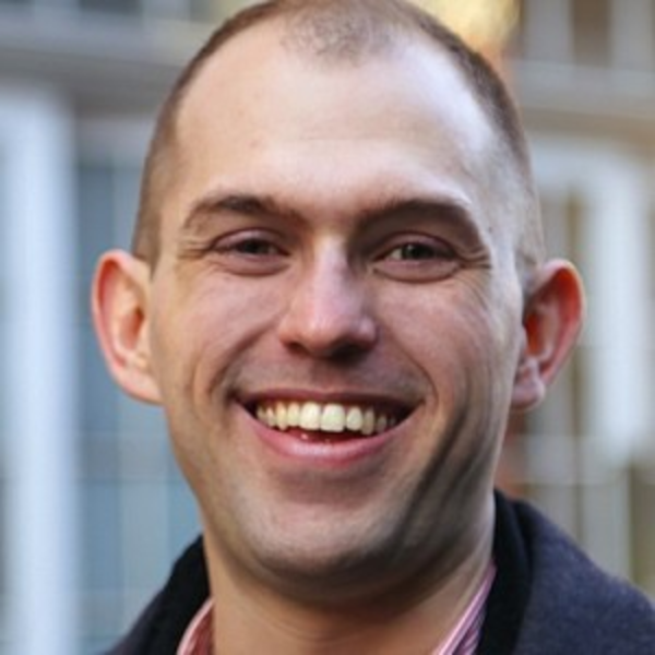 a young man smiles at the camera