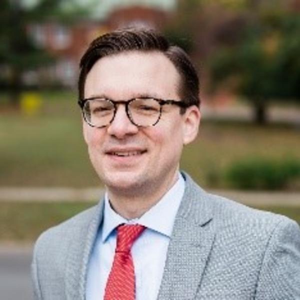 a man in a suit and glasses