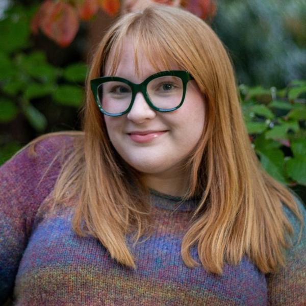 a young woman with long hair and glasses