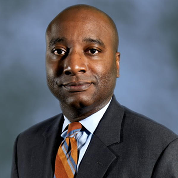 headshot of an African American man in a suit and tie