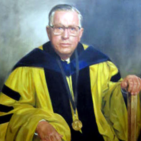 an older male professor in academic robes