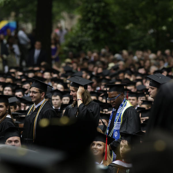 The senior class gather's in Fisher Garden for commencement.