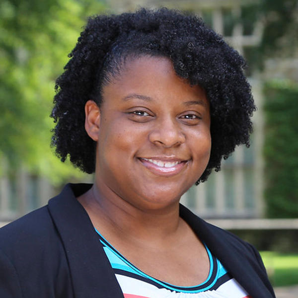 An African American woman smiles at the camera