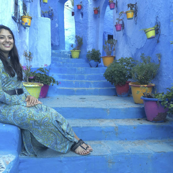 a young woman sits on a painted staircase in Greece