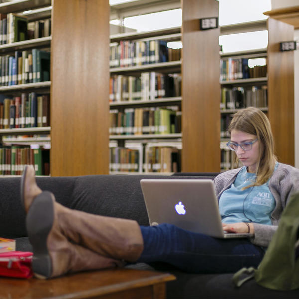 a student looks at a computer in the library