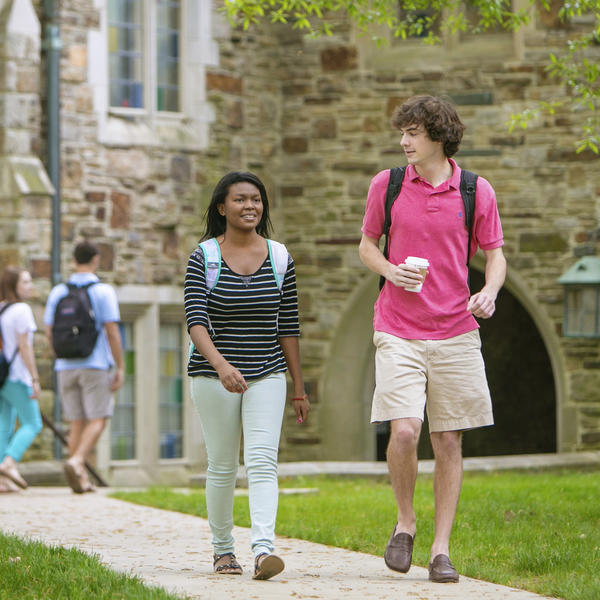 an male and female student walk across campus