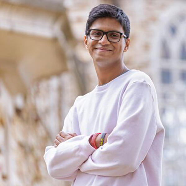 a young man with dark hair and glasses