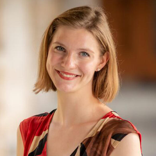 a young woman with short hair smiles at the camera