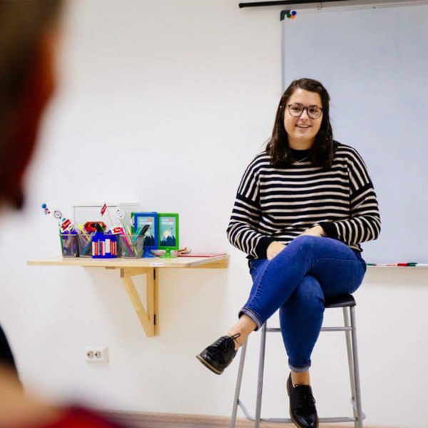 a young woman talks to a class