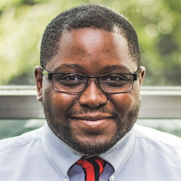 an African American man smiles at the camera