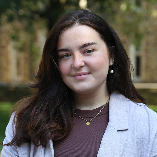 a young woman with long dark hair smiles at the camera