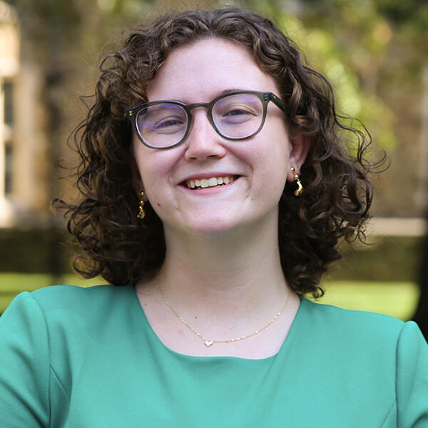 a young woman with glasses and shorter wavy hair