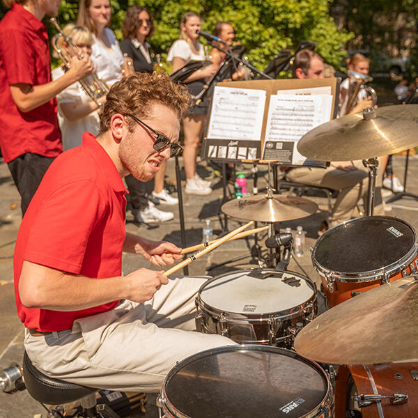 a young man drums onstage