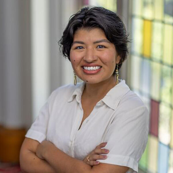 a young woman with short dark hair smiles at the camera