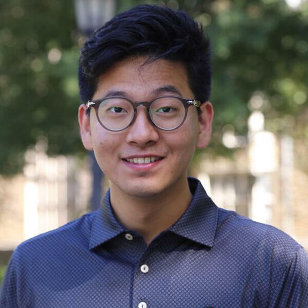 a young Asian man with glasses