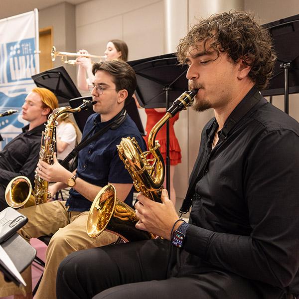 students playing saxophones in a concert