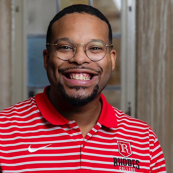 Simeon Glover, a young African American man in glasses and a short beard