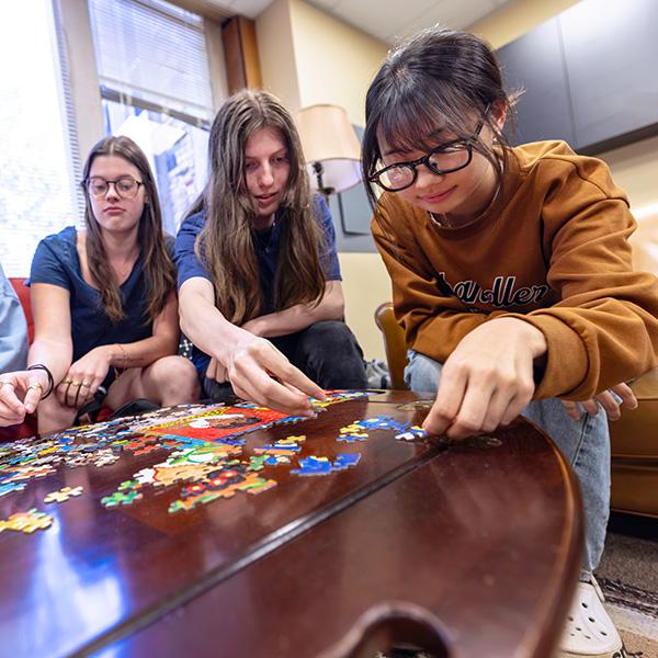 students gather around a table