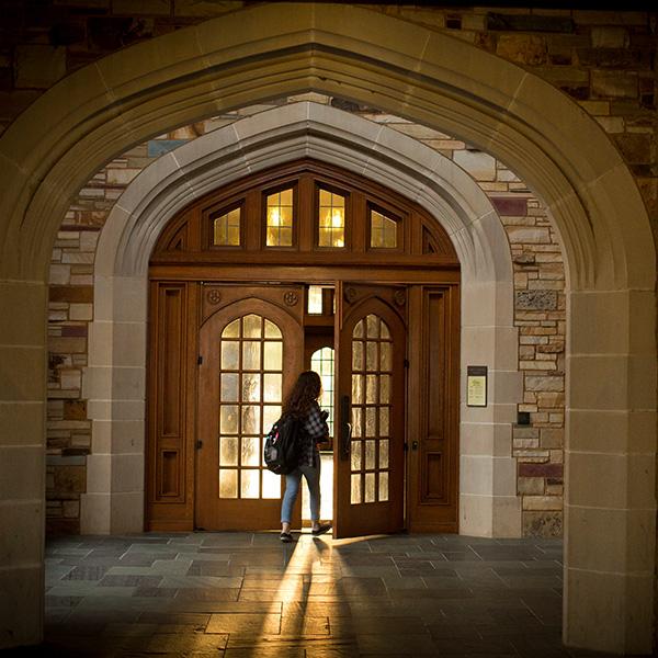 a student enters a Gothic building