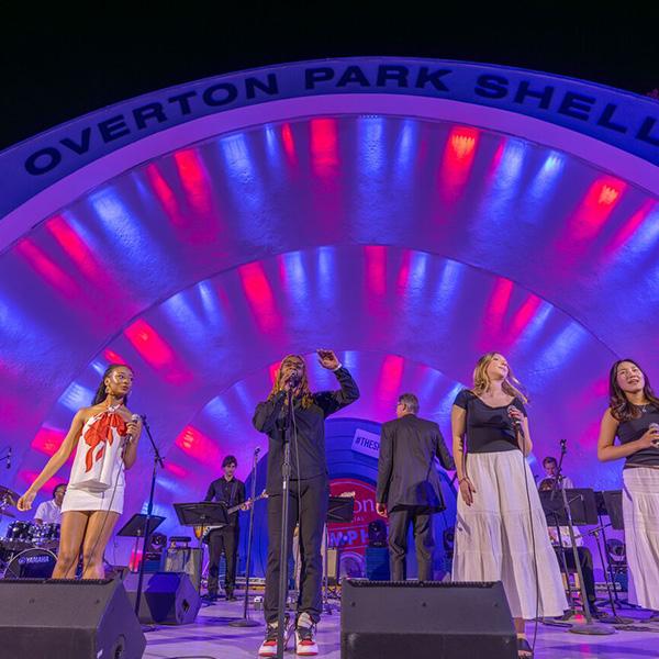 singers on a lighted stage