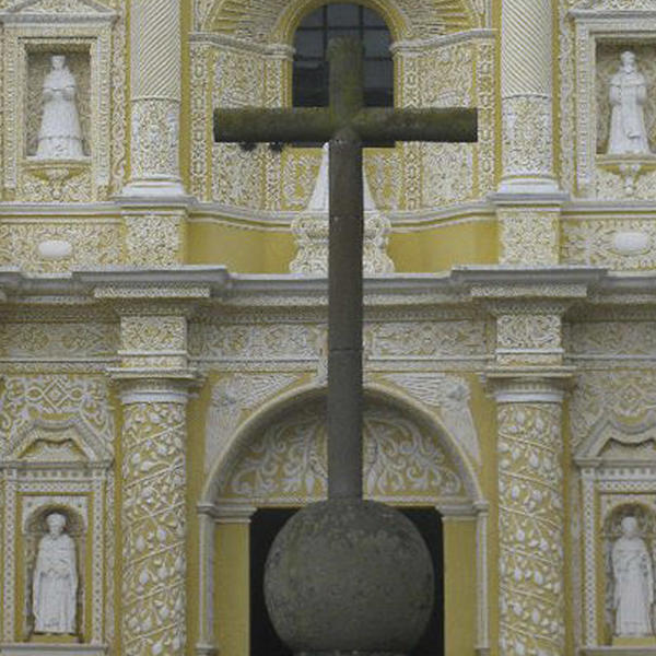 a cross outside an ornate church