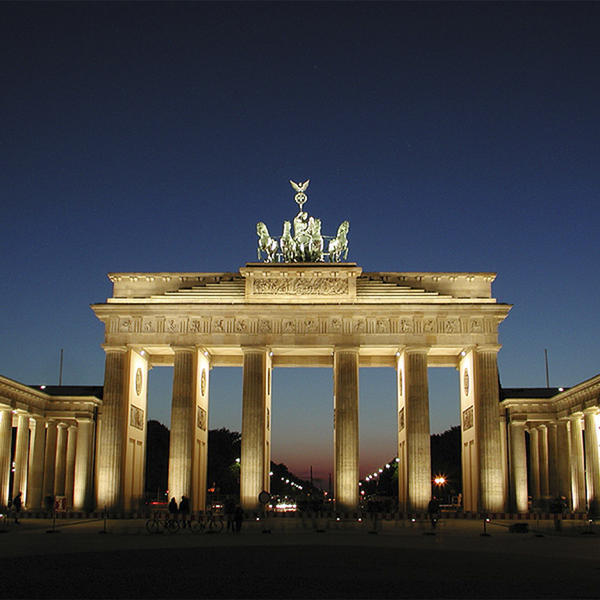 Tall arch with multiple columns lighted at night