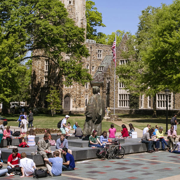 Many students sitting outside around the Diehl statue