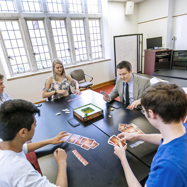 students gather around a table