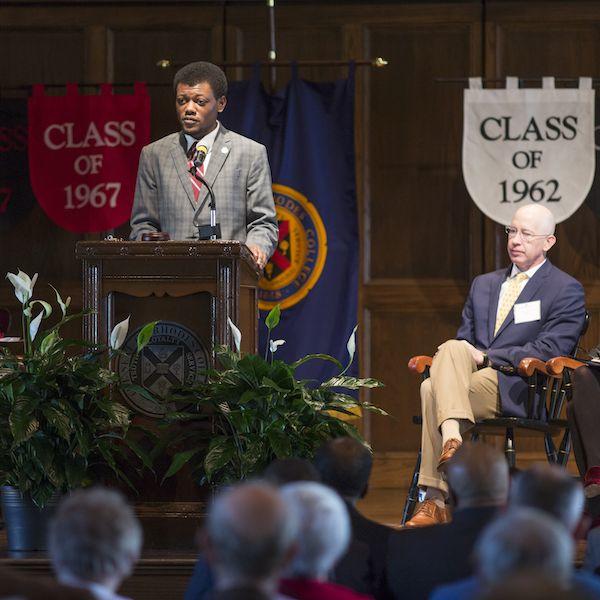 a young Black man speaks at a lectern