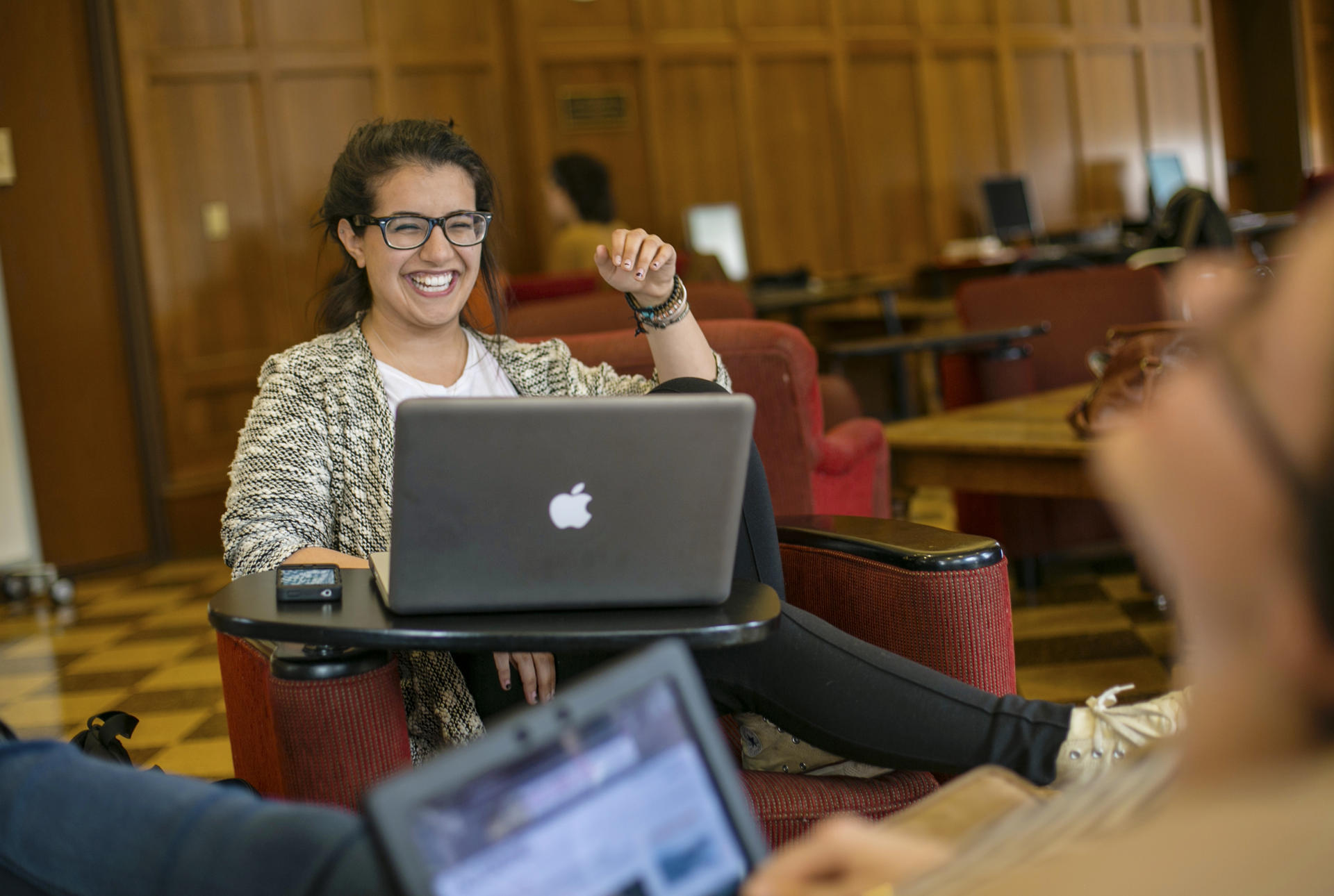 A student at a desk with a laptop