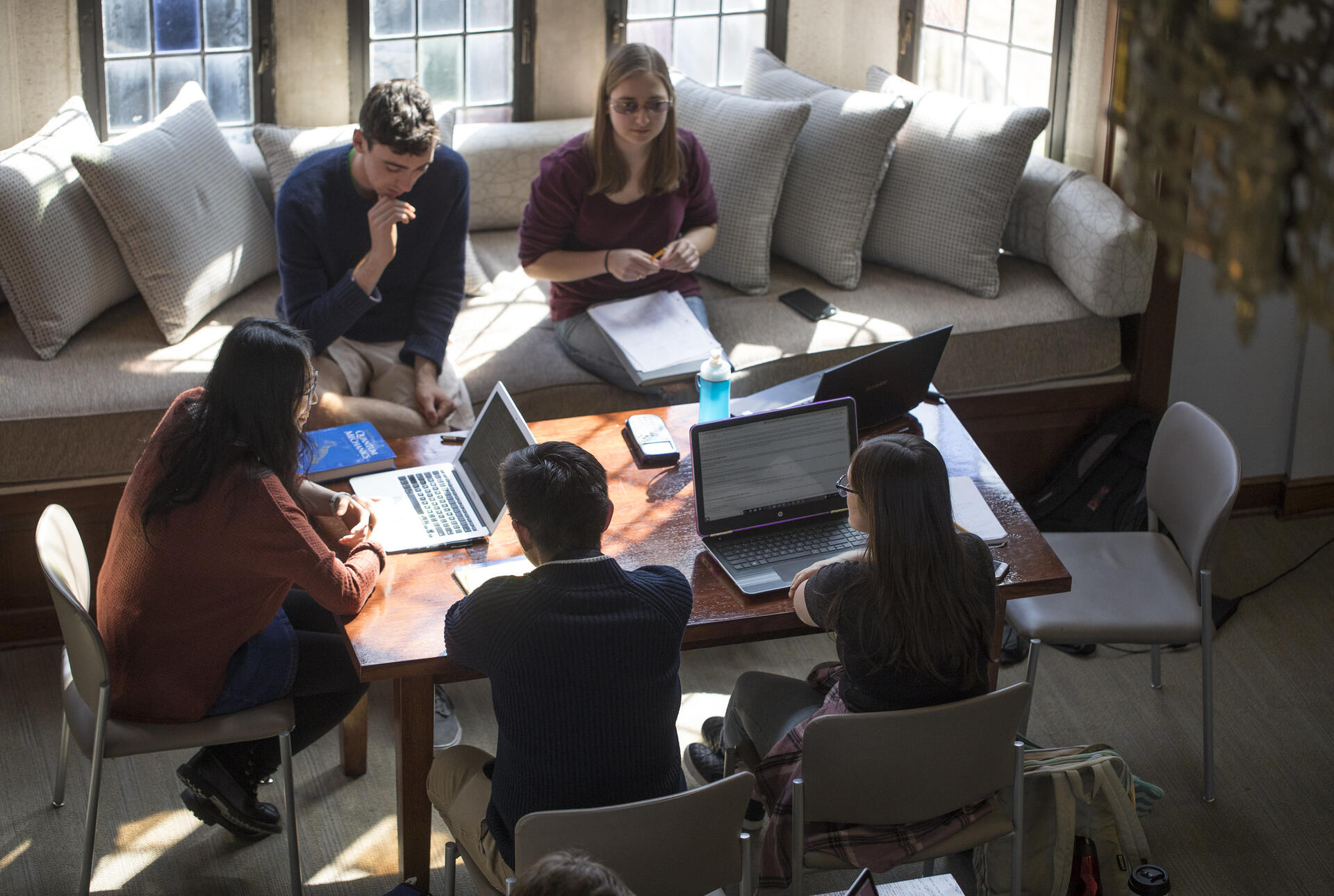students study around a table in the math library