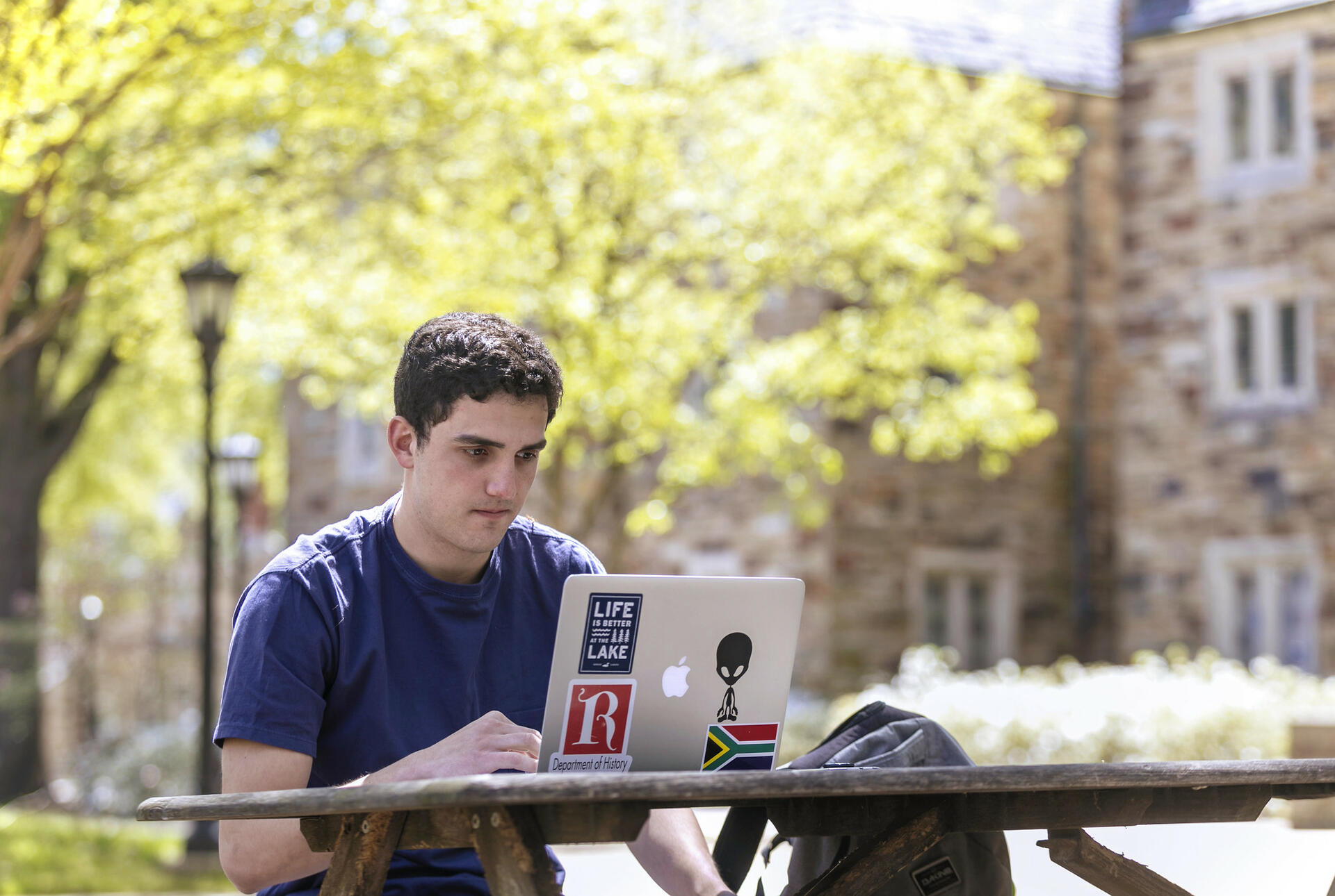 a male student looking at a laptop