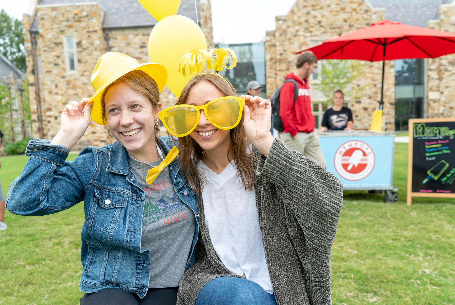 two students wearing hats and large sunglasses 