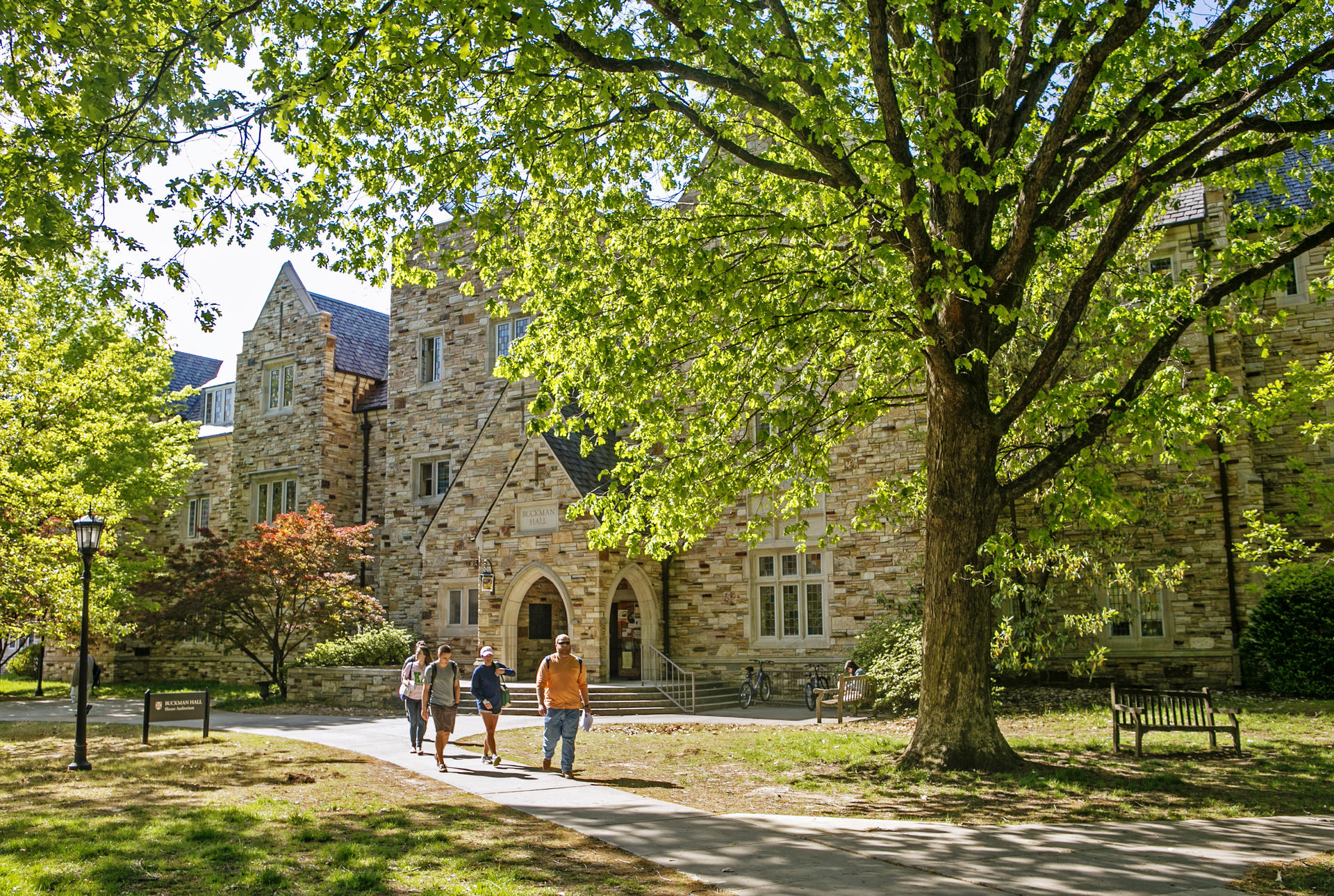 a Gothic stone building with a sign saying Buckman Hall
