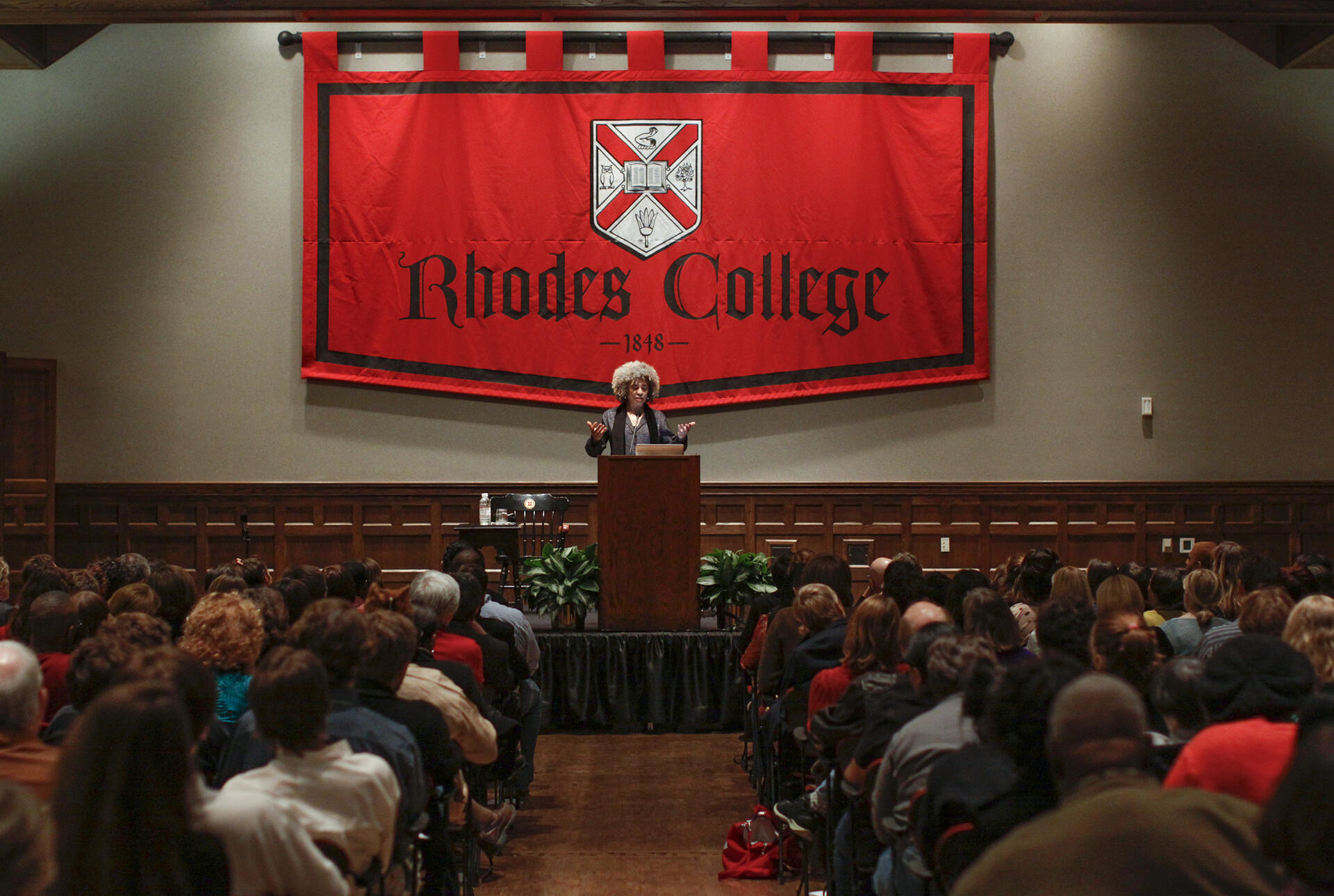 an African American woman speaks to a crowd