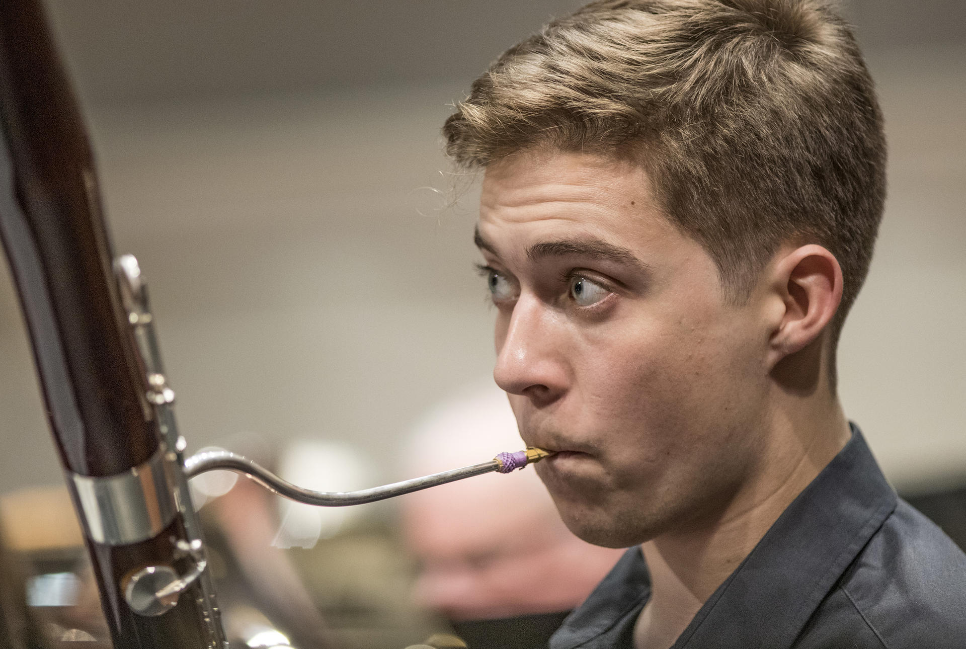 a young man plays the oboe