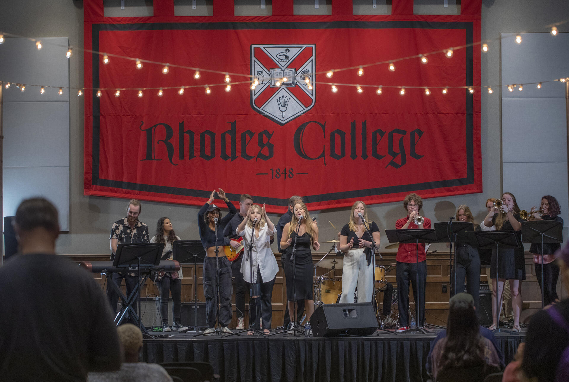 a large groups of students perform on stage