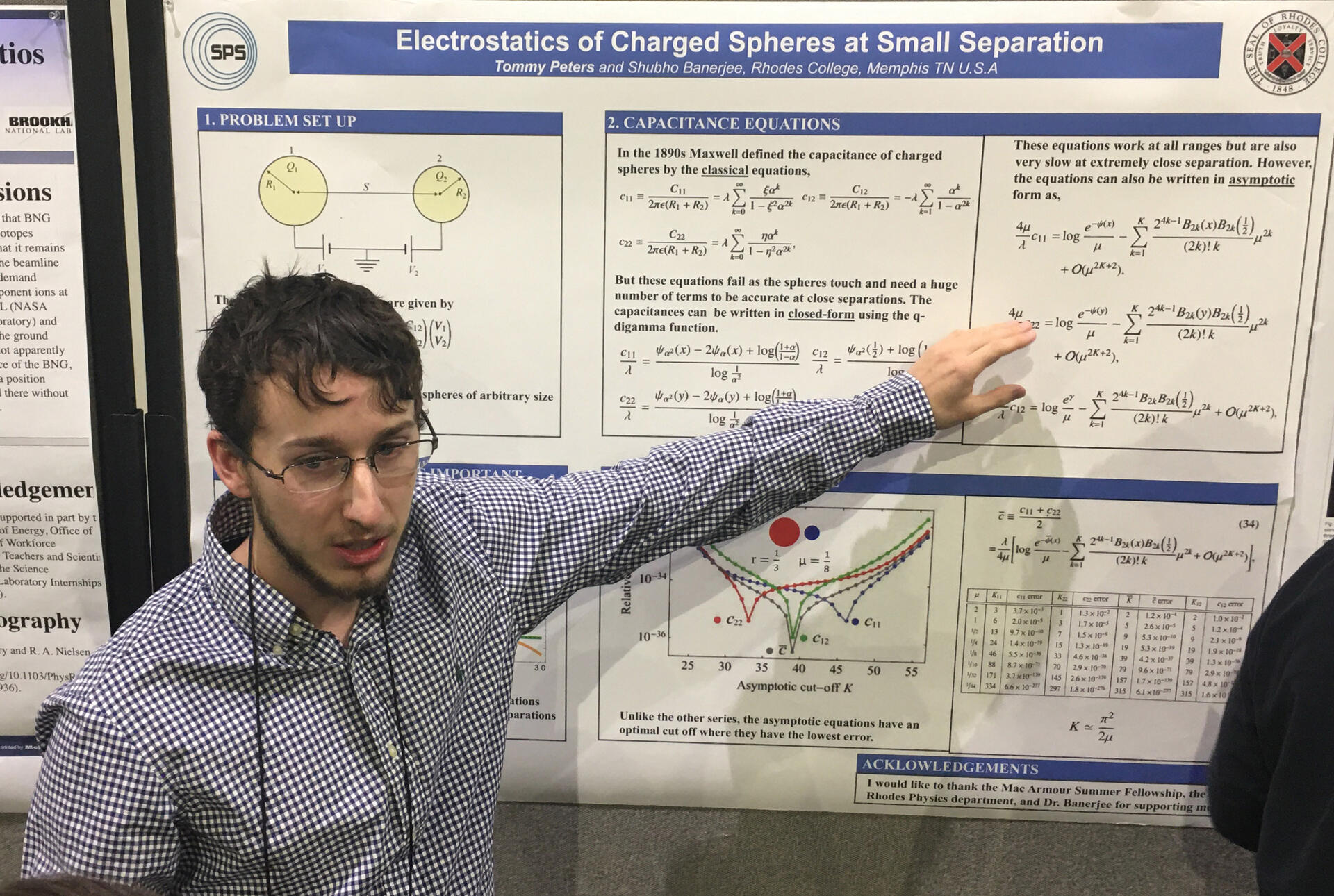 a male student presents a poster on physics